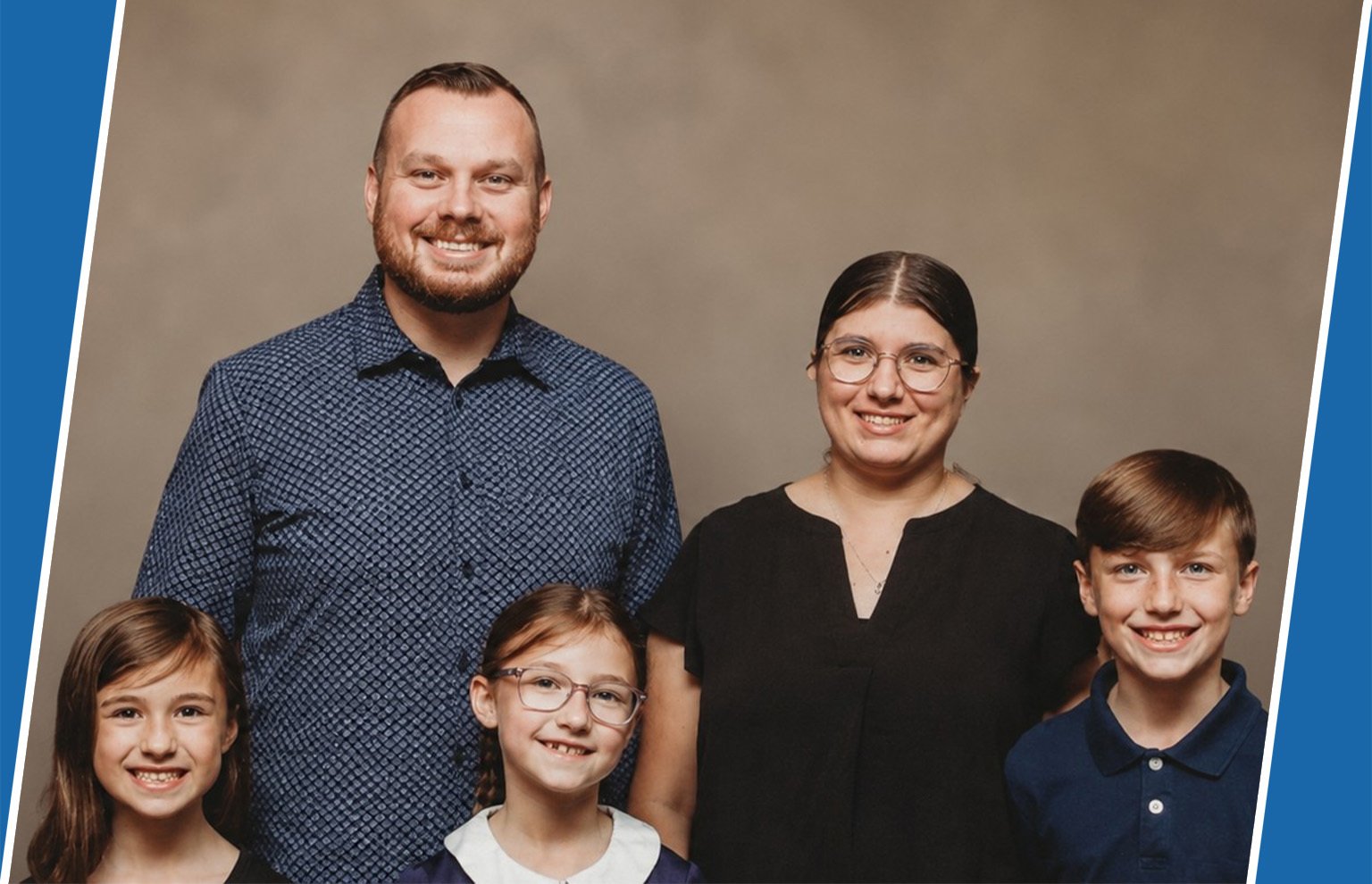 Family portrait of two parents and three children smiling together
