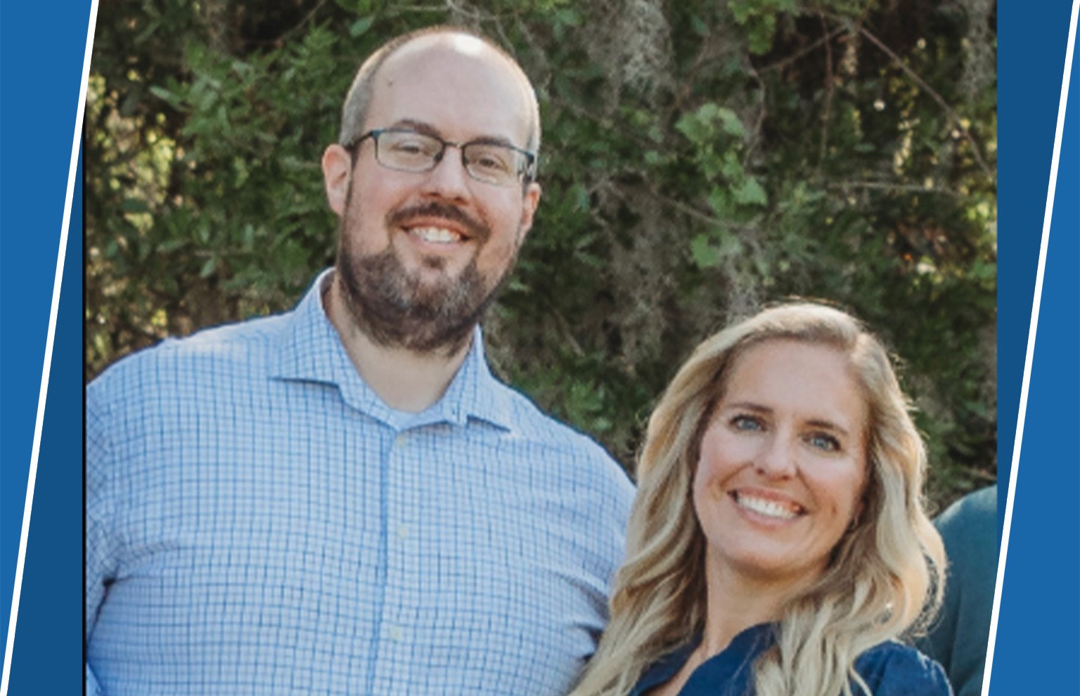 Smiling bearded man with glasses beside a smiling blonde woman outdoors